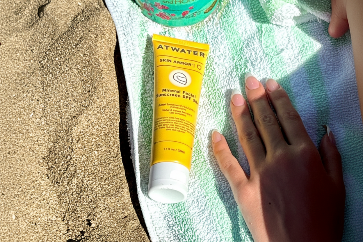 Tube of Atwater Mineral Facial Sunscreen on a towel with sand nearby
